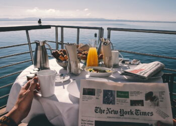 person holding white ceramic mugg