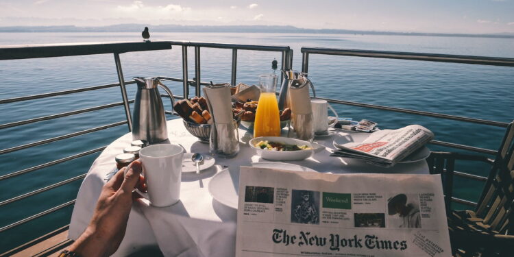 person holding white ceramic mugg