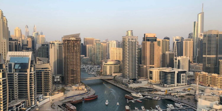 high rise buildings near calm water at daytime