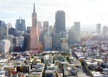 aerial photography of concrete buildings under blue cloudy sky