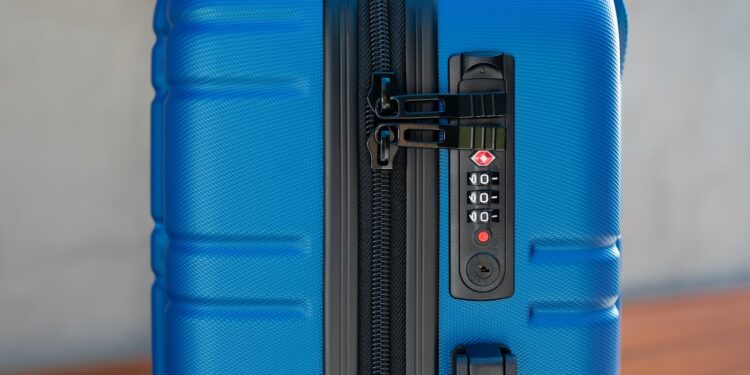 a blue piece of luggage sitting on top of a wooden table