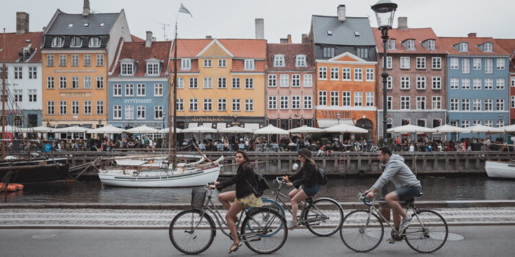 three people riding bicycles