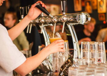 person holding handle of faucet