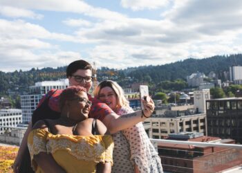 man taking photo of women