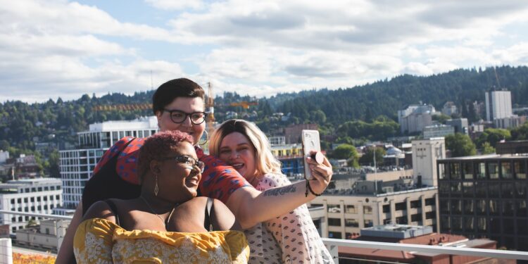 man taking photo of women