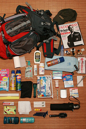 English: Packing for a trip. Equipment include...