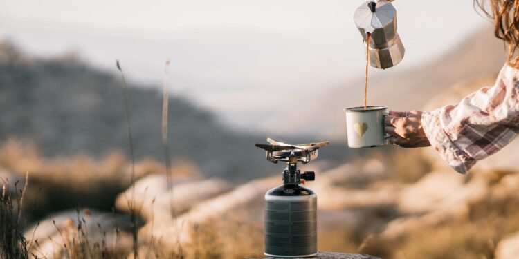 Person Pouring Brown Liquid on White Ceramic Mug