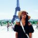 woman standing behind Eiffel Tower during daytime