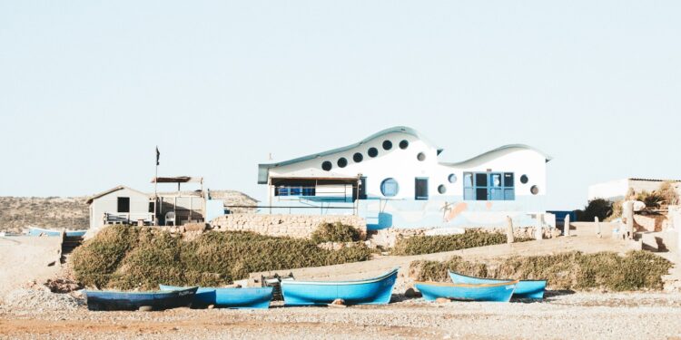 blue boats docked near the seashore