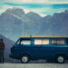 man and woman standing beside blue van