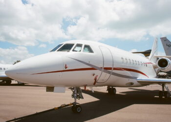 white airplane under white clouds during daytime