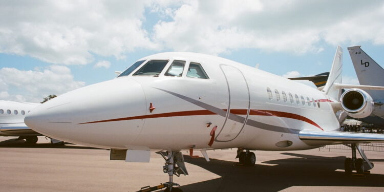 white airplane under white clouds during daytime