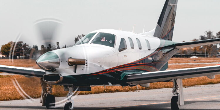 white and gray monoplane on runway at day time