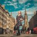 woman in black and red floral dress standing on the street