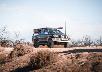 white and black jeep wrangler on brown field during daytime