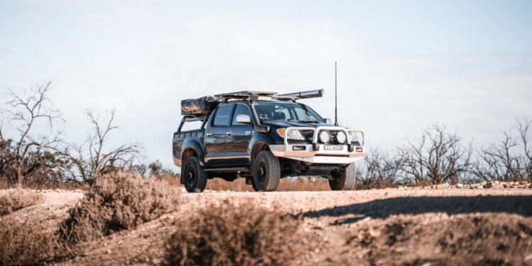 white and black jeep wrangler on brown field during daytime
