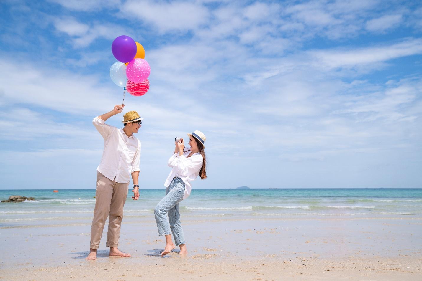 A person flying a kite on the beach

Description automatically generated