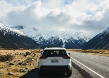 white suv on road near snow covered mountain during daytime