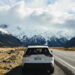 white suv on road near snow covered mountain during daytime